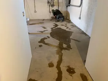 Repairs filled across a hallway slab before the epoxy goes down — a Greater Cincinnati job