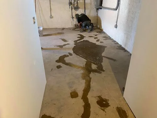 Repairs filled across a hallway slab before the epoxy goes down, on a Greater Cincinnati job
