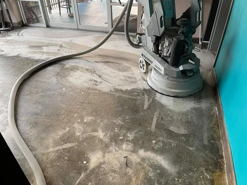 Floor grinder taking an old slab down to clean concrete before coating, on a Greater Cincinnati job