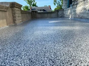 Flake epoxy on a covered balcony between stone columns — a Greater Cincinnati job