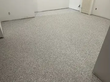 Gray flake epoxy running into a basement room — a Greater Cincinnati job