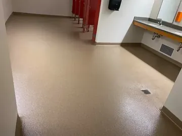 Beige flake epoxy along a commercial restroom's sink wall — a Greater Cincinnati job