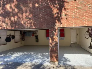 Flake epoxy garage floor beside a brick column — a Greater Cincinnati job