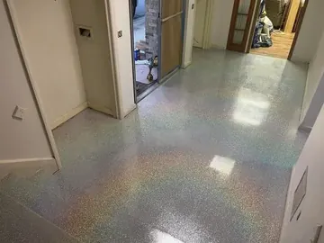 Gray flake epoxy with a glitter top coat in a hallway — a Greater Cincinnati job