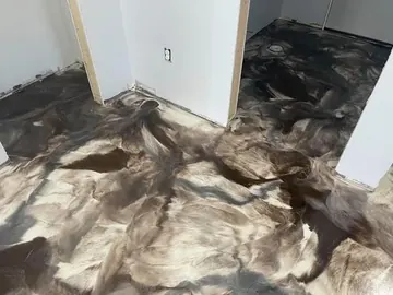 Dark swirled metallic epoxy across a basement — a Greater Cincinnati job