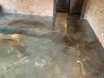 Four-color metallic epoxy in a brick-walled room — a Greater Cincinnati job