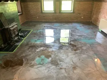 Four-color metallic epoxy near a brick wall and window — a Greater Cincinnati job