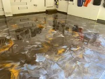 Gray and gold metallic epoxy floor in a garage — a Greater Cincinnati job